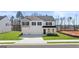 Two-story home featuring a three-car garage and classic black shutters, showcasing a well-manicured lawn at 1949 Van Allen Ct # 4, Dacula, GA 30019