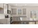 Bright kitchen featuring granite countertops, stainless steel appliances, gray cabinets and hardwood floors at 1949 Van Allen Ct # 4, Dacula, GA 30019