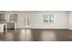 Open-concept living space with wood flooring, light gray kitchen, and natural light at 1949 Van Allen Ct # 4, Dacula, GA 30019