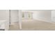 Large living room with neutral carpet, white walls, and multiple windows at 1949 Van Allen Ct # 4, Dacula, GA 30019