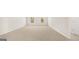 Spacious living room featuring neutral carpet, white walls, and natural light from windows at 1949 Van Allen Ct # 4, Dacula, GA 30019