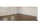 Bright living room featuring wood floors, white walls, and two windows at 1949 Van Allen Ct # 4, Dacula, GA 30019