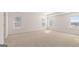 Bright and spacious main bedroom with three large windows and neutral carpet at 1949 Van Allen Ct # 4, Dacula, GA 30019