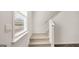 Carpeted staircase with white banister and a window offering natural light at 1949 Van Allen Ct # 4, Dacula, GA 30019