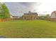 Spacious backyard with a privacy fence, providing ample space for recreation and outdoor activities at 321 Champions Dr, Fairburn, GA 30213