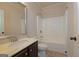 Bathroom with a vanity, toilet, and shower-tub combo featuring a white surround and a curved shower rod at 321 Champions Dr, Fairburn, GA 30213