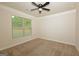 A cozy bedroom featuring neutral walls, carpet flooring, and a ceiling fan at 321 Champions Dr, Fairburn, GA 30213