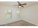 Comfortable bedroom with natural light from two windows and a ceiling fan at 321 Champions Dr, Fairburn, GA 30213