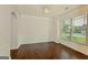 A formal dining room with decorative chandelier, wainscoting, and hardwood floors at 321 Champions Dr, Fairburn, GA 30213