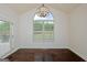 Bright dining room featuring a large window and hardwood floors at 321 Champions Dr, Fairburn, GA 30213