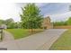 Spacious driveway leading to a well-maintained home with mature trees at 321 Champions Dr, Fairburn, GA 30213