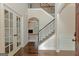 Elegant foyer with hardwood floors, staircase, and an open view to the living room at 321 Champions Dr, Fairburn, GA 30213