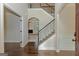 Elegant foyer with hardwood floors, staircase, and an open view to the living room at 321 Champions Dr, Fairburn, GA 30213