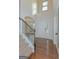 Inviting foyer with hardwood floors and an open staircase leading to the upper level at 321 Champions Dr, Fairburn, GA 30213