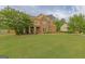 Beautiful home exterior featuring a well-maintained lawn and lush greenery at 321 Champions Dr, Fairburn, GA 30213
