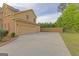 Attached two-car garage with ample parking space and exterior lighting at 321 Champions Dr, Fairburn, GA 30213