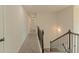 Hallway with carpet flooring, wooden handrail, and a hallway light at 321 Champions Dr, Fairburn, GA 30213