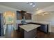 Kitchen with granite counters, dark cabinetry, stainless steel appliances, and hardwood floors at 321 Champions Dr, Fairburn, GA 30213