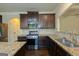 Kitchen with stainless steel appliances, granite countertops, dark cabinets, and hardwood floors at 321 Champions Dr, Fairburn, GA 30213