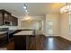Open kitchen featuring granite countertops, dark cabinetry, stainless steel appliances, and hardwood floors at 321 Champions Dr, Fairburn, GA 30213