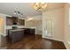 Kitchen with granite countertops, stainless steel appliances, dark cabinetry, hardwood floors, and a breakfast nook at 321 Champions Dr, Fairburn, GA 30213