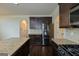 Kitchen with granite counters, dark cabinetry, stainless steel appliances, and hardwood floors at 321 Champions Dr, Fairburn, GA 30213