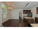 Spacious kitchen with granite countertops, stainless steel appliances, dark cabinetry, and hardwood floors at 321 Champions Dr, Fairburn, GA 30213
