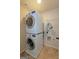 Efficient laundry room with stacked washer and dryer, and tile flooring at 321 Champions Dr, Fairburn, GA 30213