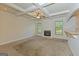 Living room with trey ceilings, fireplace, carpet, and lots of natural light at 321 Champions Dr, Fairburn, GA 30213
