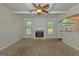 Spacious living room with coffered ceiling, fireplace, plush carpeting, and lots of natural light at 321 Champions Dr, Fairburn, GA 30213