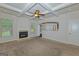 Cozy living room with a fireplace, coffered ceiling, carpeted floor, and large windows at 321 Champions Dr, Fairburn, GA 30213