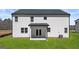 The backyard features a well-maintained lawn, the home's exterior, and a covered patio at 1950 Van Allen Ct, Dacula, GA 30019