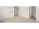Spacious bedroom featuring neutral carpet, white walls and trim, with views into the attached bath and closet at 1950 Van Allen Ct, Dacula, GA 30019