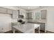 A modern kitchen featuring stainless steel appliances, light gray cabinets, granite countertops, and a kitchen island at 1950 Van Allen Ct, Dacula, GA 30019