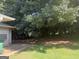 View of a backyard featuring lush greenery and shaded areas at 6050 Great Oaks Dr, Lithonia, GA 30058