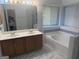 Bathroom featuring double sink vanity, bathtub, and lots of natural light at 6050 Great Oaks Dr, Lithonia, GA 30058