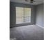 Comfortable bedroom with carpet flooring, large window offering natural light, and ample space at 6050 Great Oaks Dr, Lithonia, GA 30058