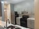 Contemporary kitchen with gray cabinets, marble counters, and stainless-steel appliances at 6050 Great Oaks Dr, Lithonia, GA 30058