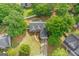 Aerial view of home with mature trees, long driveway, and a well-maintained lawn at 556 Walton Dr, Social Circle, GA 30025