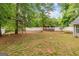 Large backyard featuring wooden pergola and white vinyl fence at 556 Walton Dr, Social Circle, GA 30025