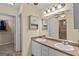 Bathroom featuring a double sink vanity with a large mirror and a walk-in closet at 556 Walton Dr, Social Circle, GA 30025