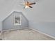 Cozy bedroom with light blue walls, carpeted floor, ceiling fan and dormer window at 556 Walton Dr, Social Circle, GA 30025