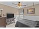 Cozy bedroom featuring a ceiling fan and a comfortable bed with a black comforter at 556 Walton Dr, Social Circle, GA 30025