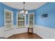 Cozy dining area with natural light from multiple windows, ideal for Gathering meals at 556 Walton Dr, Social Circle, GA 30025