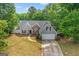 Charming single-Gathering home featuring gray siding, stone accents, and a two-car garage at 556 Walton Dr, Social Circle, GA 30025