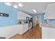 Bright kitchen with white cabinets, stainless steel appliances, and wood flooring at 556 Walton Dr, Social Circle, GA 30025