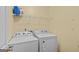 Convenient laundry room equipped with a washer, dryer, and storage shelves for supplies at 556 Walton Dr, Social Circle, GA 30025