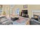 Spacious living room with fireplace, plush seating, and view into dining area at 556 Walton Dr, Social Circle, GA 30025