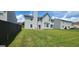 An exterior view of a spacious backyard shows green grass and the rear of the house at 1762 Wood Stork Drive, Hampton, GA 30228