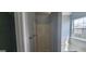 Clean bathroom with shower and separate tub, next to a window for natural light at 1762 Wood Stork Drive, Hampton, GA 30228